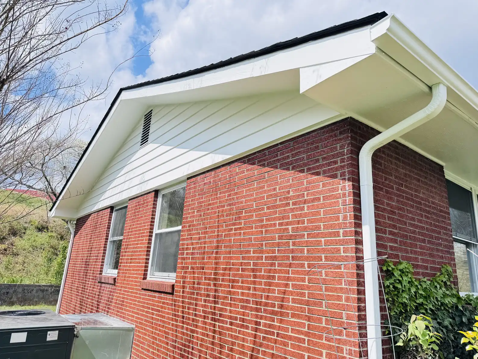White trim and gable painted on a brick home