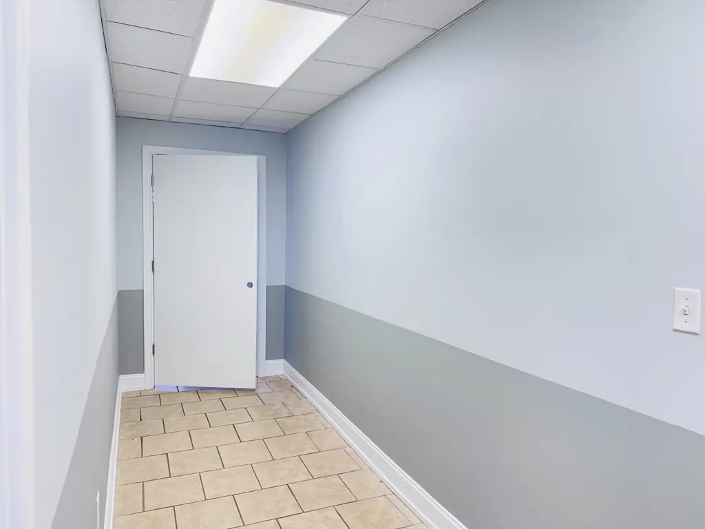 Commercial hallway painted in two tones of gray